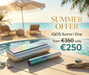 IQOS Iluma i One device on a wooden deck with a beach and pool in the background, promoting a summer offer.